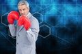 Composite image of tough businessman with boxing gloves Royalty Free Stock Photo