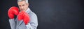 Composite image of tough businessman with boxing gloves Royalty Free Stock Photo