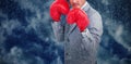 Composite image of tough businessman with boxing gloves Royalty Free Stock Photo