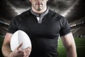 Composite image of tough rugby player holding ball Royalty Free Stock Photo