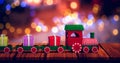 Composite image of train set with gift boxes