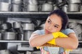 Composite image of troubled woman leaning on a mop