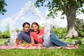 Composite image of two friends looking ahead while they hold glasses as they have a picnic