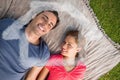 Composite image of two friends looking towards the sky while lying on a quilt