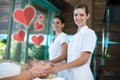 Composite image of two masseuses giving head massage with love hearts Royalty Free Stock Photo