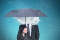 Composite image of unsmiling businessman sheltering under umbrella