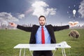 Composite image of unsmiling businessman sitting with arms outstretched Royalty Free Stock Photo