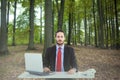 Composite image of unsmiling businessman sitting at desk Royalty Free Stock Photo