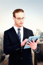 Composite image of unsmiling businessman using tablet pc Royalty Free Stock Photo