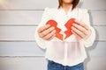 Composite image of woman holding broken heart paper Royalty Free Stock Photo