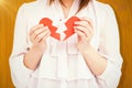 Composite image of woman holding broken heart paper Royalty Free Stock Photo