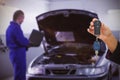 Composite image of woman holding key and small car Royalty Free Stock Photo
