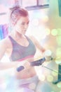 Composite image of woman pulling on row machine Royalty Free Stock Photo