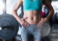 Composite image of Woman's torso in gym with flare Royalty Free Stock Photo