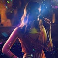 Composite image of woman singing in bar Royalty Free Stock Photo