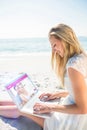 Composite image of woman using laptop and wearing hat Royalty Free Stock Photo