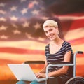 Composite image of woman in wheelchair using computer Royalty Free Stock Photo