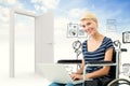 Composite image of woman in wheelchair using computer Royalty Free Stock Photo
