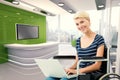 Composite image of woman in wheelchair using computer Royalty Free Stock Photo