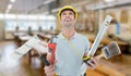 Composite image of worker holding various equipment over white background Royalty Free Stock Photo