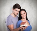 Composite image of young couple holding a model house Royalty Free Stock Photo