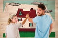 Composite image of young couple painting with roller Royalty Free Stock Photo