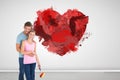 Composite image of young couple painting with roller Royalty Free Stock Photo