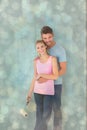 Composite image of young couple painting with roller Royalty Free Stock Photo