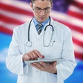 Composite image of young doctor using digital tablet Royalty Free Stock Photo