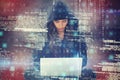 Composite image of young female hacker using laptop while sitting
