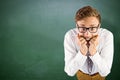 Composite image of young geeky businessman biting his nails