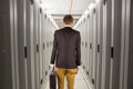 Composite image of young geeky businessman holding briefcase