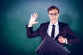 Composite image of young geeky businessman holding briefcase Royalty Free Stock Photo