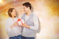 Composite image of young man giving present to woman Royalty Free Stock Photo