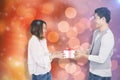 Composite image of young man giving present to woman Royalty Free Stock Photo