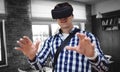 Composite image of young man using virtual reality simulator glasses Royalty Free Stock Photo