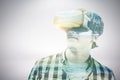 Composite image of young man wearing virtual reality glasses Royalty Free Stock Photo