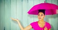 Composite image of young woman carrying pink umbrella Royalty Free Stock Photo