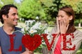 Composite image of young woman holding her hands against her face when presented with flowers Royalty Free Stock Photo