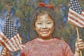 Composite mosaic image of a girl holding American flags