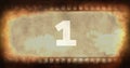 Composite of number 1 text over old rusty negative camera film with vignette, copy space Royalty Free Stock Photo