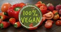 Composite of 100 percent vegan text over fruit and vegetables