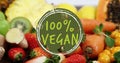 Composite of 100 percent vegan text over fruit and vegetables