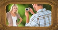 Composite of picture frame and caucasian man photographing smiling young woman with digital camera