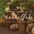Composite of it\'s the most wonderful time of the year text over christmas presents and pinecones
