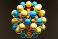 composite spherical model atom orbit with yellow and blue protons and neutrons