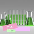 Composite of stem day text over green chemical in test tubes and flasks on white background Royalty Free Stock Photo