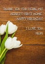 Composite of white flowers and happy birthday, i love you mom text on wooden table