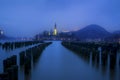 Compositing Shot of New York City Pier Poles and Bled Lake in Slovenia Royalty Free Stock Photo