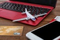 Composition with airplane model and laptop on wooden table Royalty Free Stock Photo